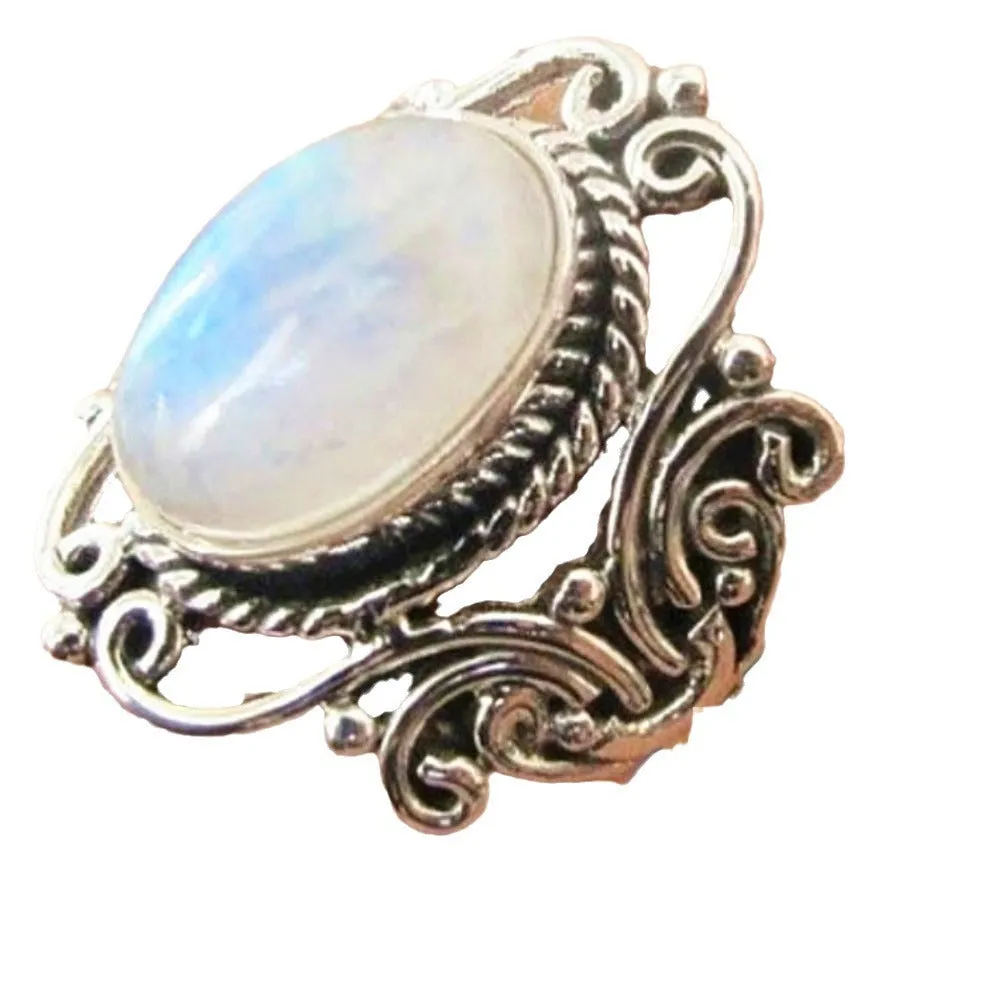 Vintage alloy ring with flower-shaped artificial moonstone gemstone on a neutral background showing side view