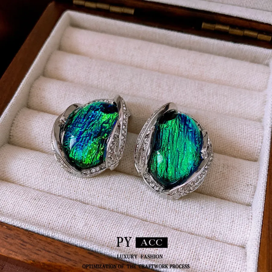 Silver resin stud earrings with rhinestone encrusting and irregular retro shape in silver needle green