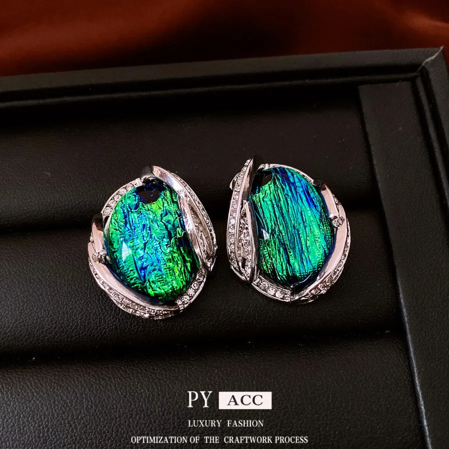 Silver resin stud earrings with rhinestone encrusting and irregular retro shape in silver needle green