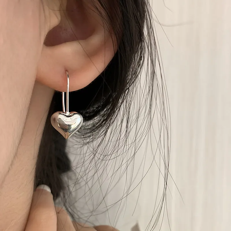 Three-dimensional glossy heart-shaped earrings in silver colour made from copper with white gold finish, Korean style for women