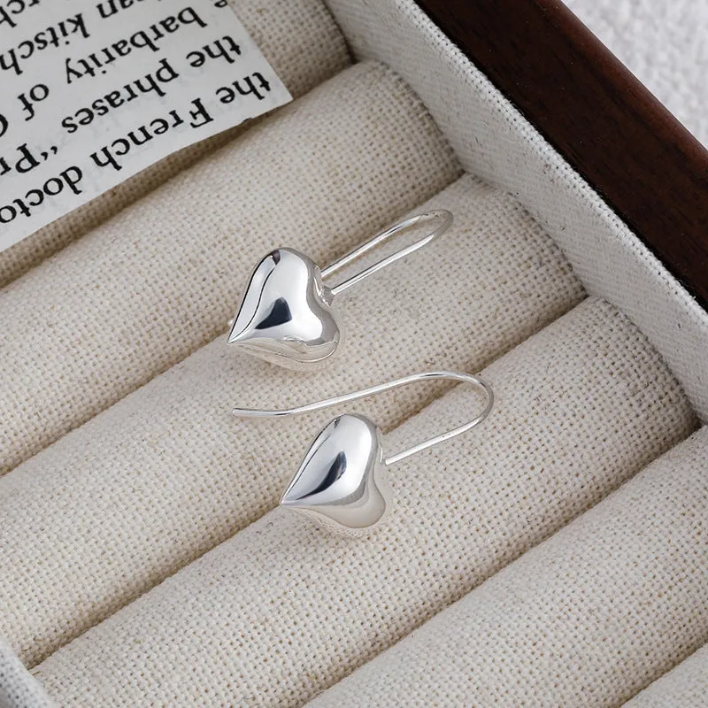 Three-dimensional glossy heart-shaped earrings in silver colour made from copper with white gold finish, Korean style for women