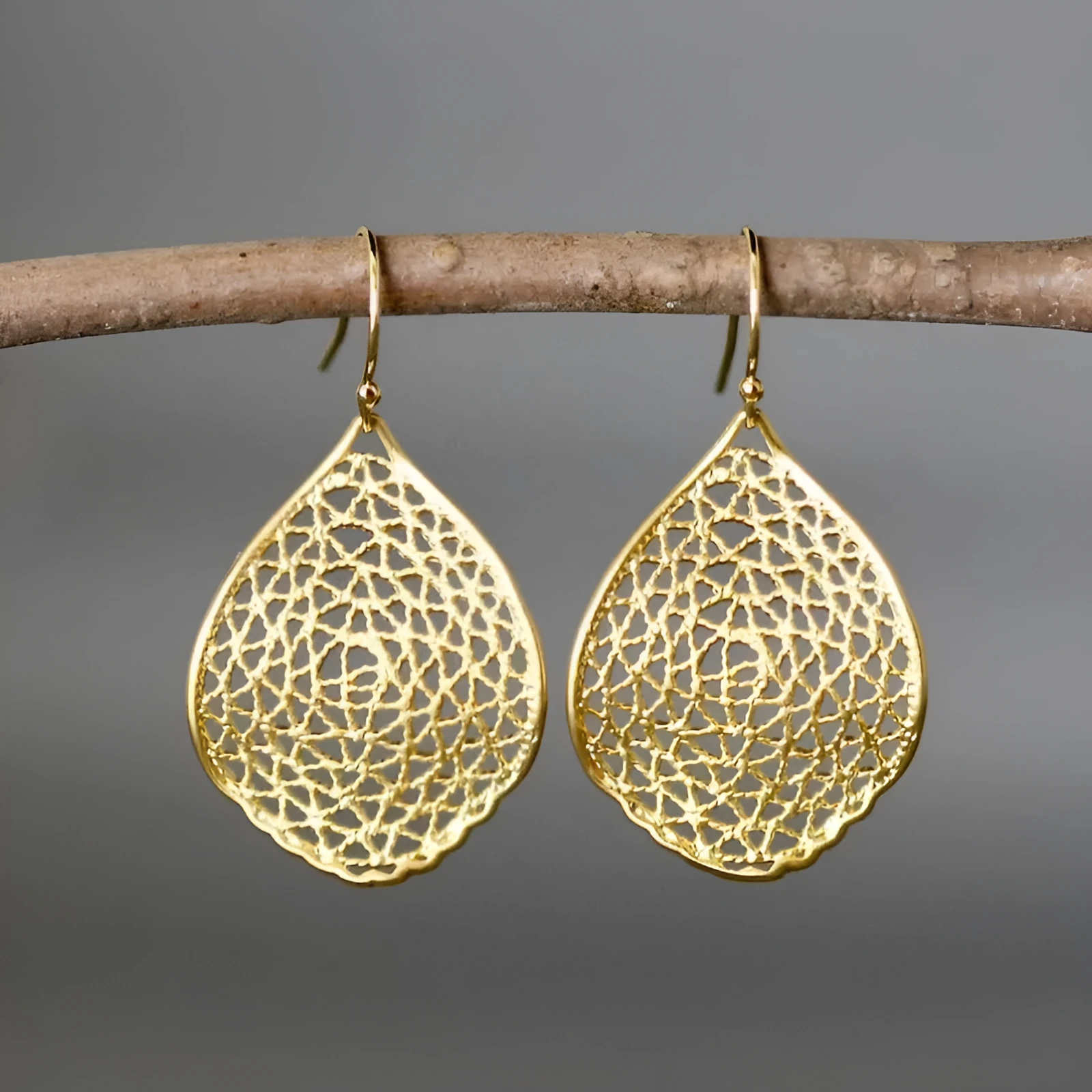 Gold alloy retro leaf hollow pendant drop earrings with vintage style design and hook fitting