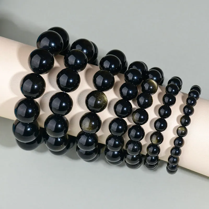 Hand-woven obsidian bracelet with round crystal beads in black stone variations including rainbow eye obsidian