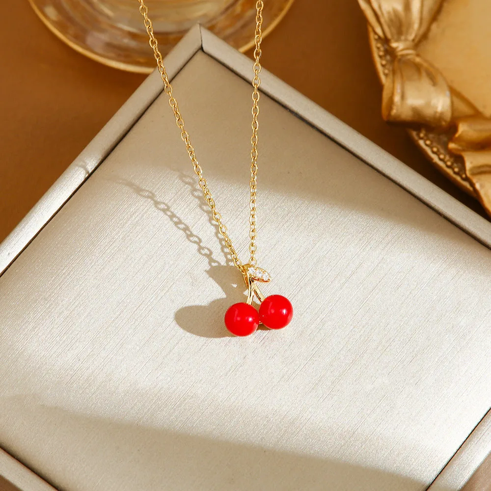Titanium steel fashion necklace with indie cherry pendant on an O-ring chain, shown in golden colour.