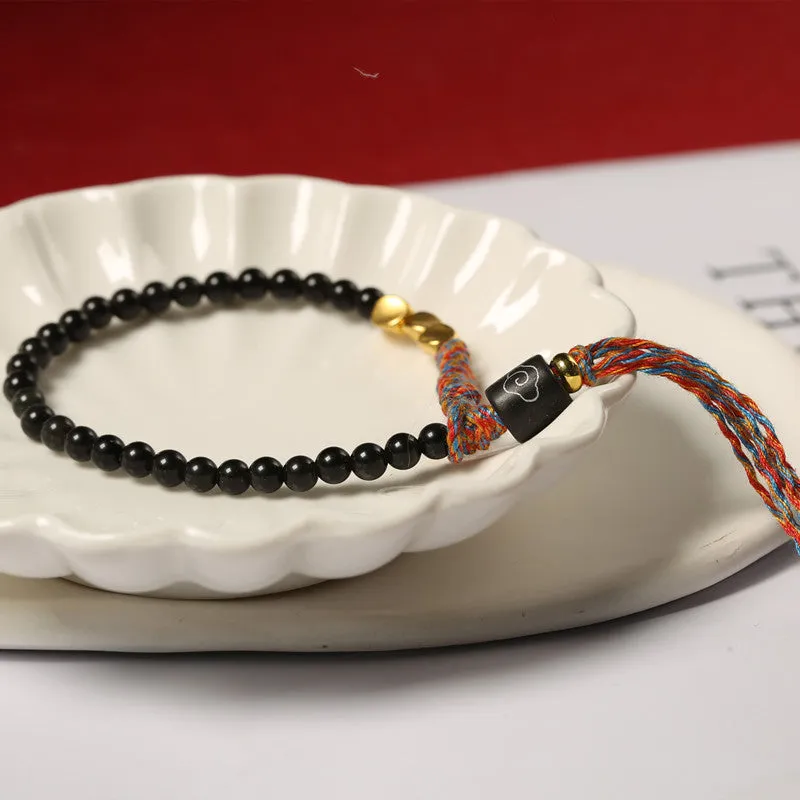 Hand-woven obsidian carrying strap bracelet showing textured surface and adjustable 15.5-16cm length