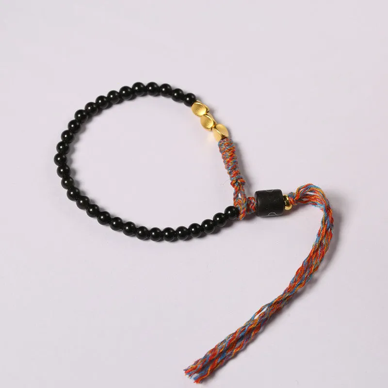 Hand-woven obsidian carrying strap bracelet showing textured surface and adjustable 15.5-16cm length
