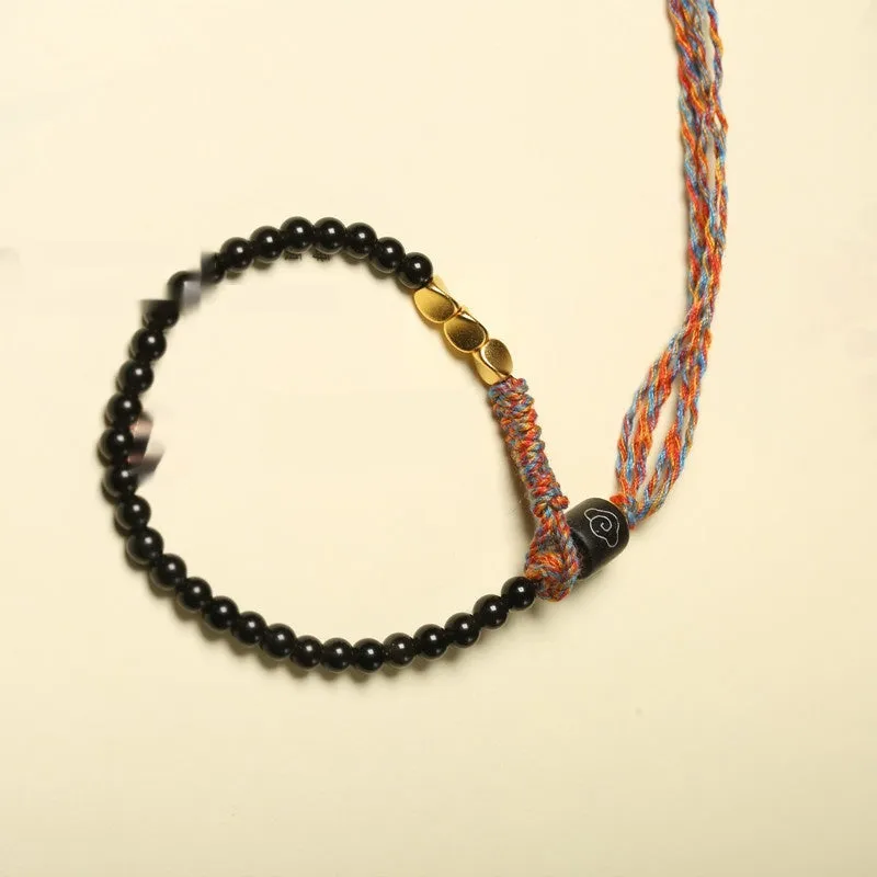 Hand-woven obsidian carrying strap bracelet showing textured surface and adjustable 15.5-16cm length