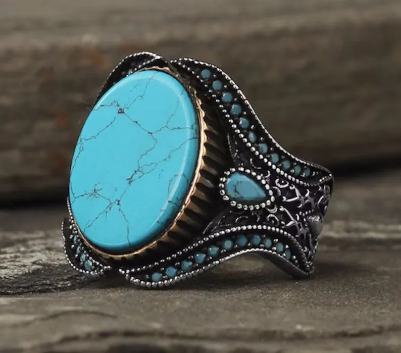 Men's round turquoise ring with antique silver alloy band, side view
