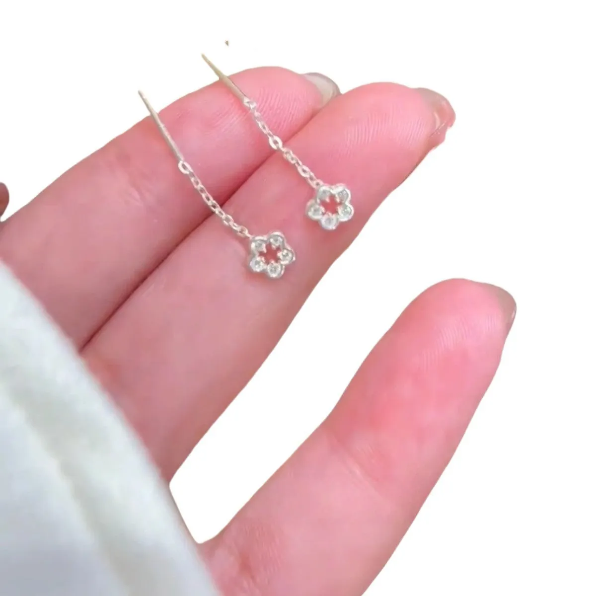 Silver flower hanging earrings for women in hollow petal design made of alloy