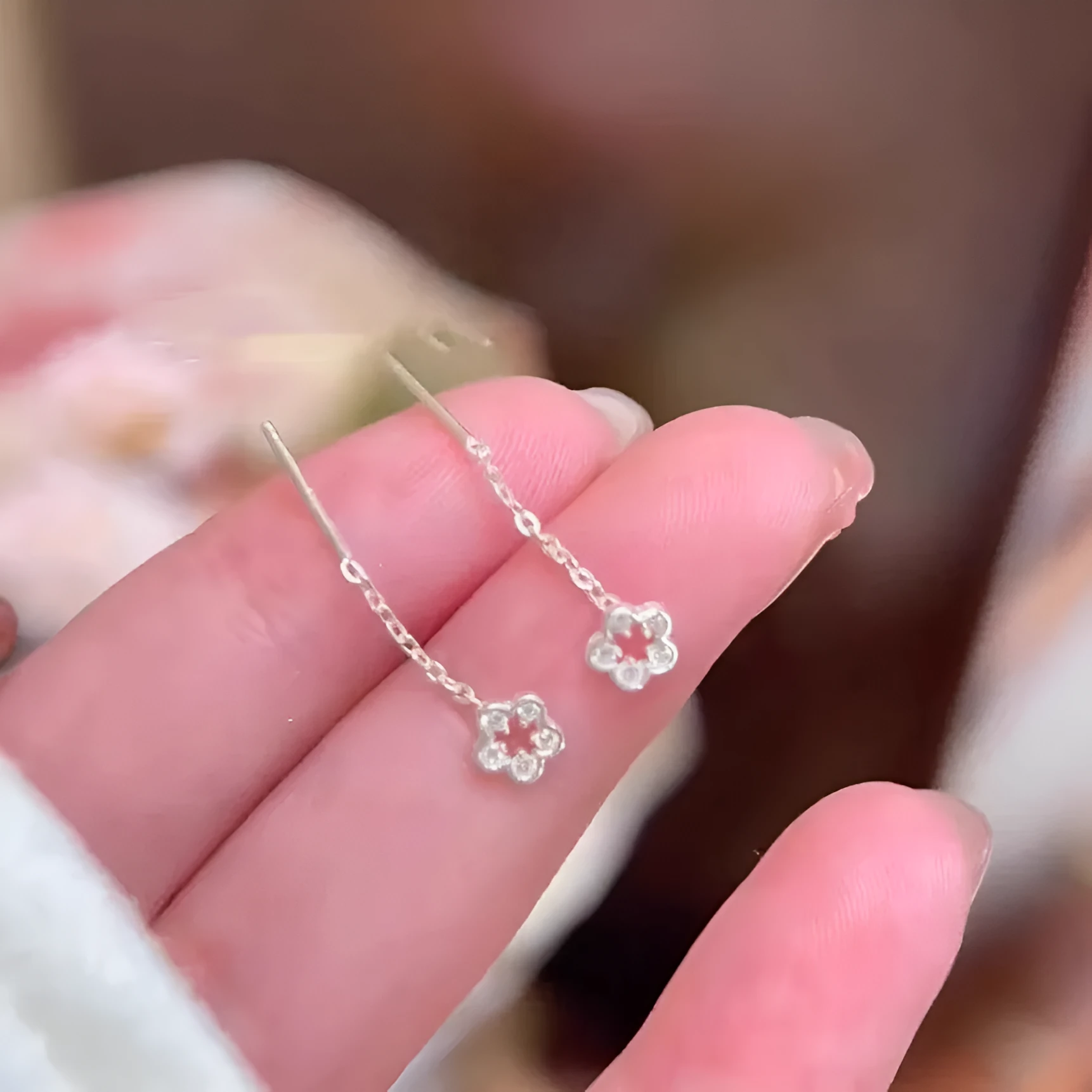 Silver flower hanging earrings for women in hollow petal design made of alloy