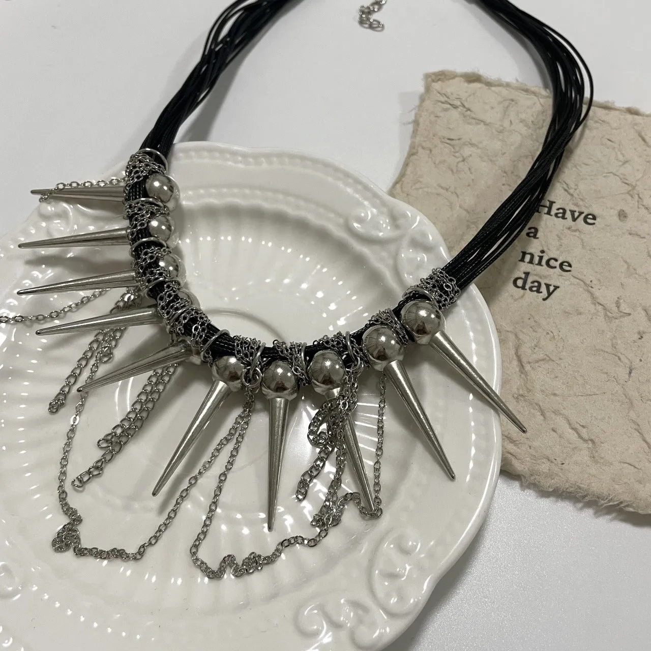 Women's casual leather necklace with electroplated rivets and winding round beads in picture colour.