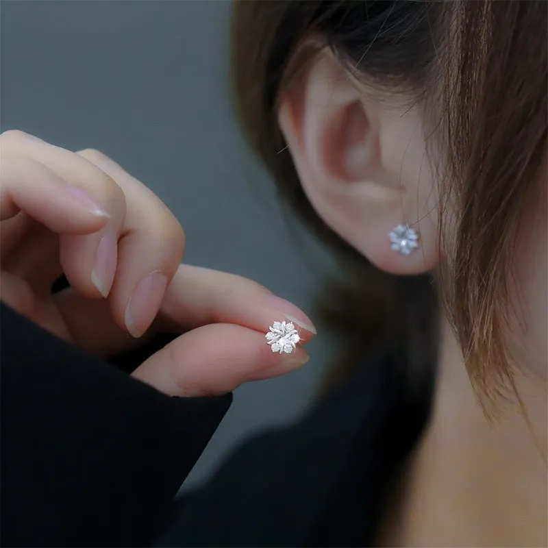 Silver snowflake ear stud earrings for women with zircon detail and copper base, geometric compact design.