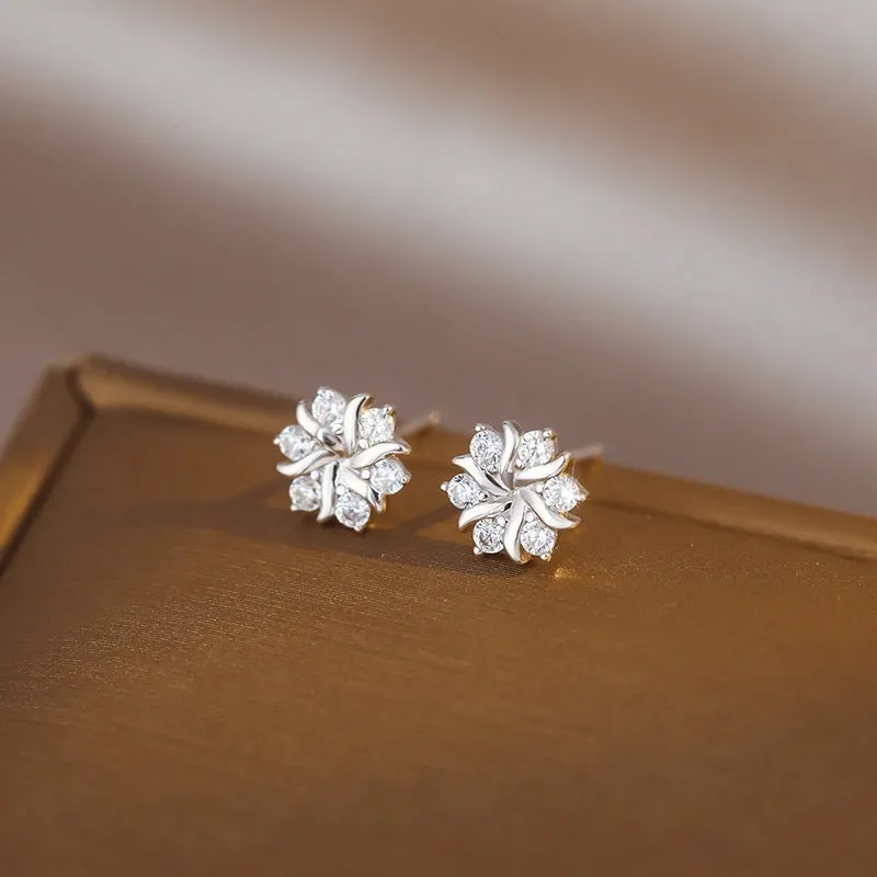 Silver snowflake ear stud earrings for women with zircon detail and copper base, geometric compact design.