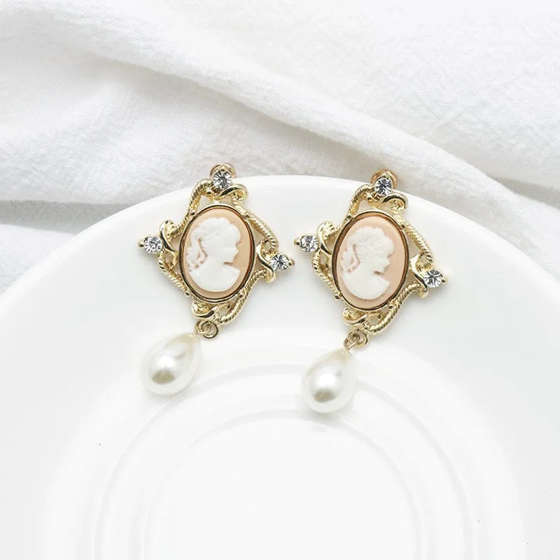 Gold alloy retro embossed geometric earrings on a surface