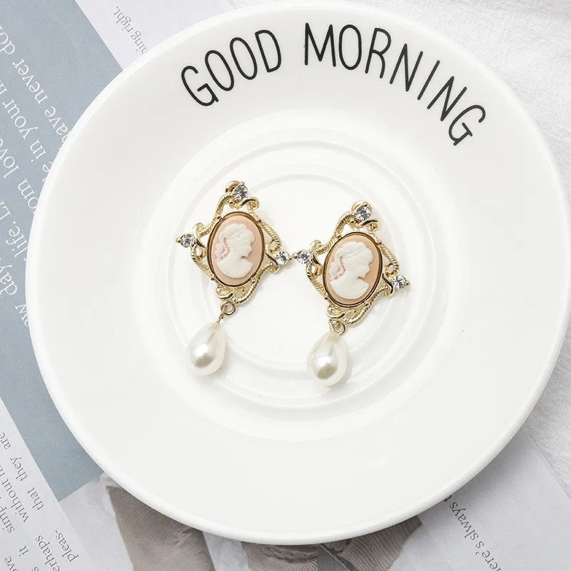 Gold alloy retro embossed geometric earrings on a surface