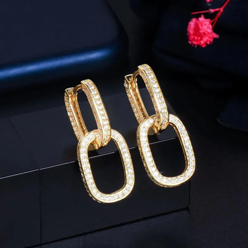 Pair of copper geometric U-shaped earrings with inlaid zircon in white gold colour