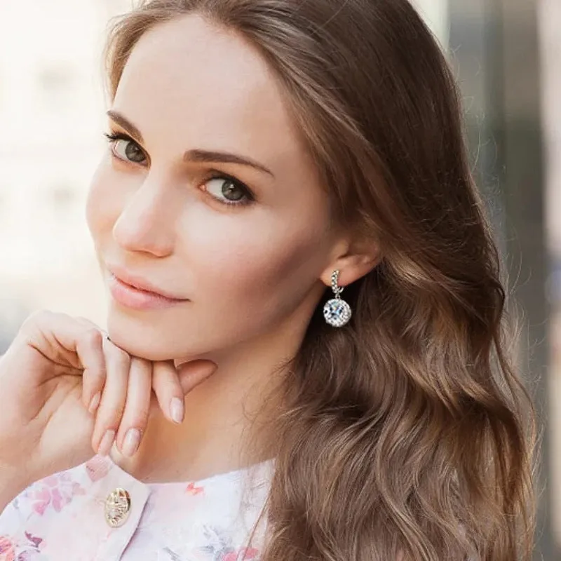 Shiny white gold copper geometric earrings for women with round ring shape on a white background