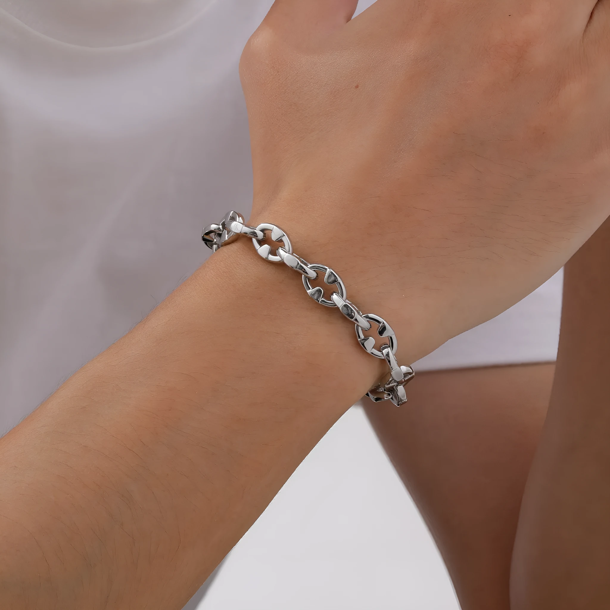 A thick handmade stainless steel bracelet with a geometric shape and steel colour finish.