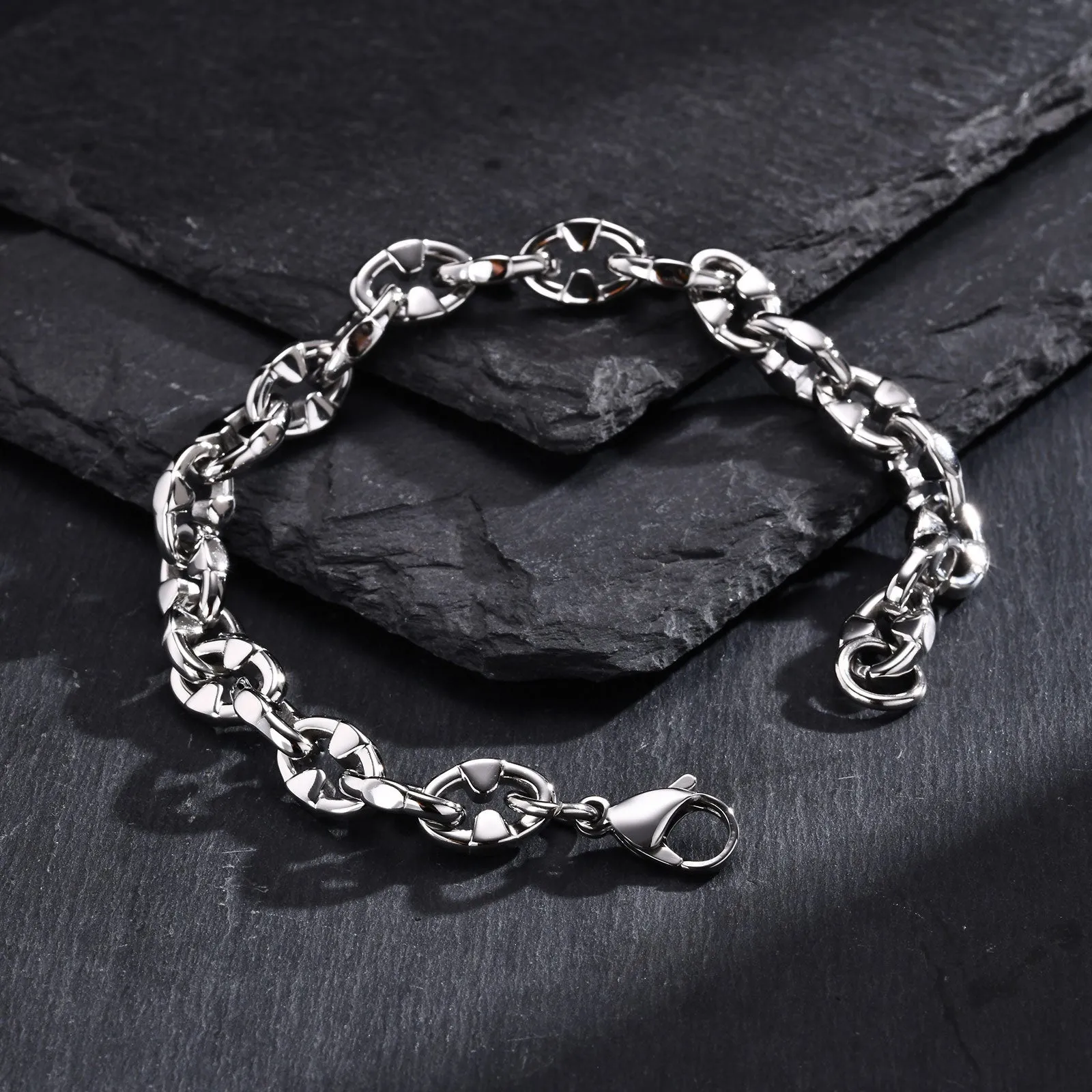 A thick handmade stainless steel bracelet with a geometric shape and steel colour finish.