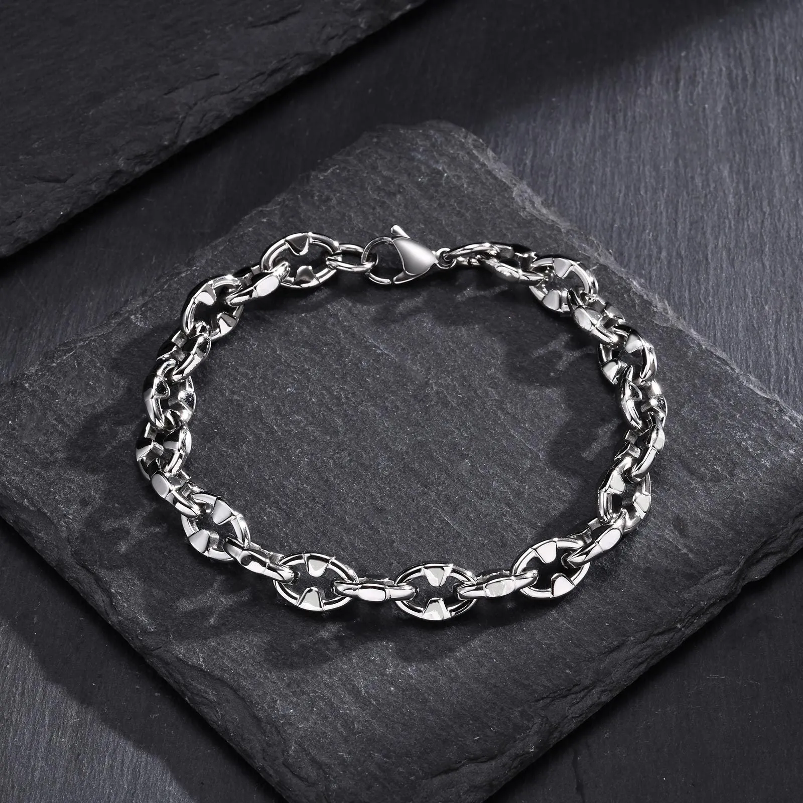 A thick handmade stainless steel bracelet with a geometric shape and steel colour finish.