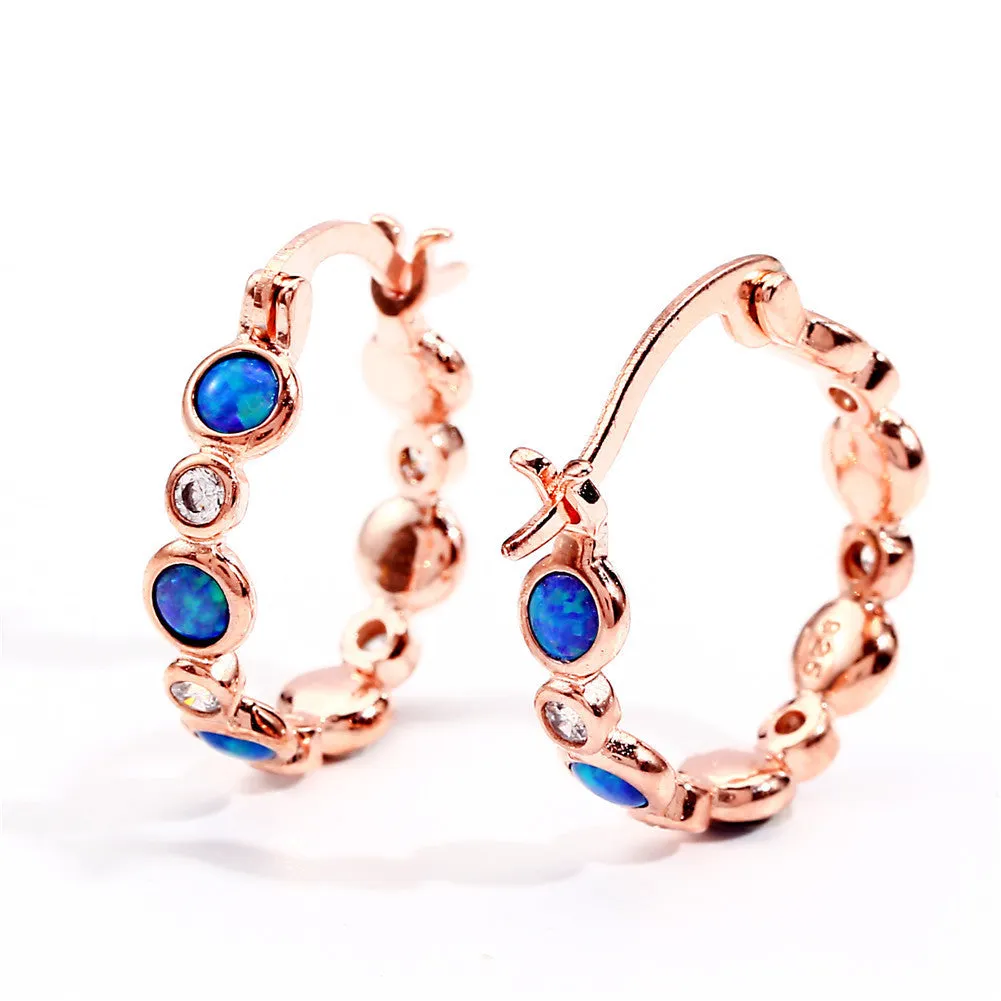 Round copper earrings with synthetic opal and cubic zirconia in platinum white finish