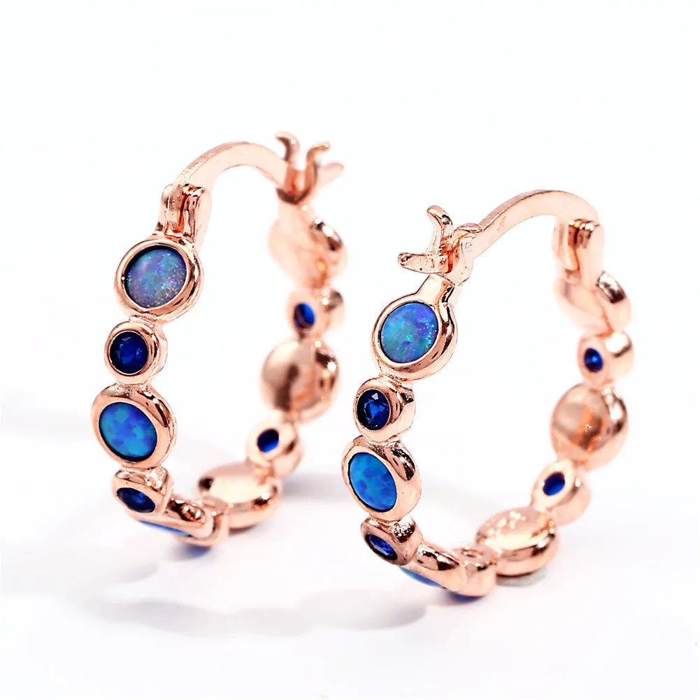 Round copper earrings with synthetic opal and cubic zirconia in platinum white finish
