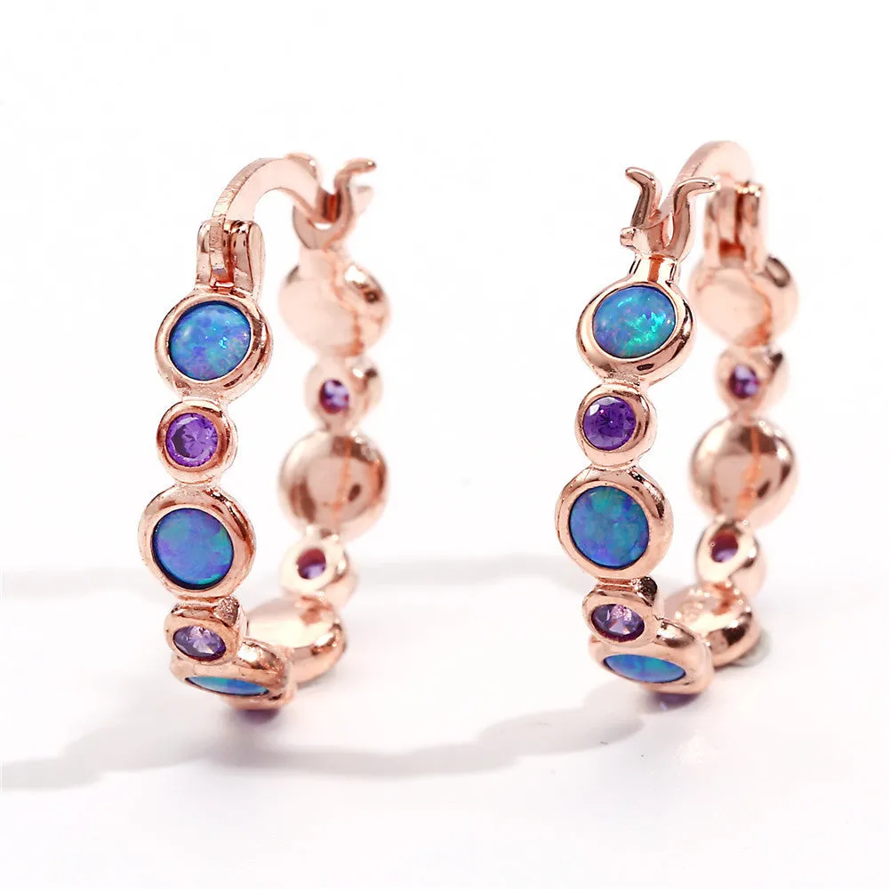 Round copper earrings with synthetic opal and cubic zirconia in platinum white finish