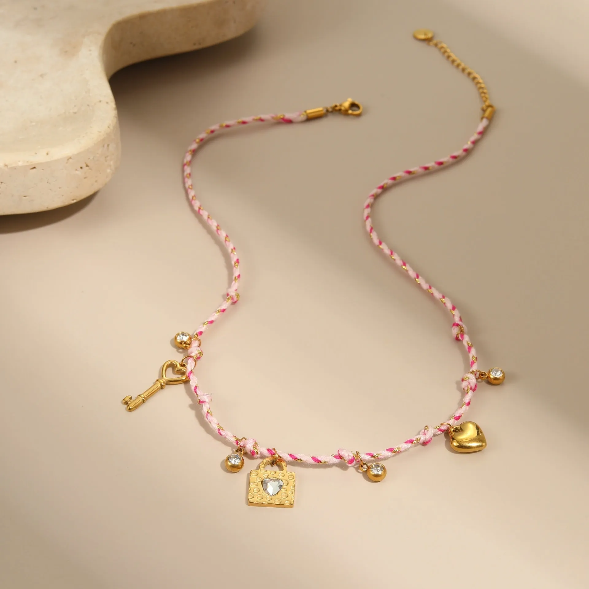 Handmade stainless steel necklace with coloured braided rope detail and geometric pendant