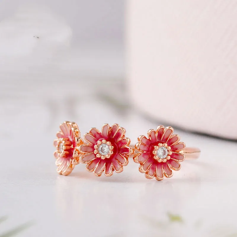 Three pink daisy rings with pink gemstone inlay in 925 sterling silver