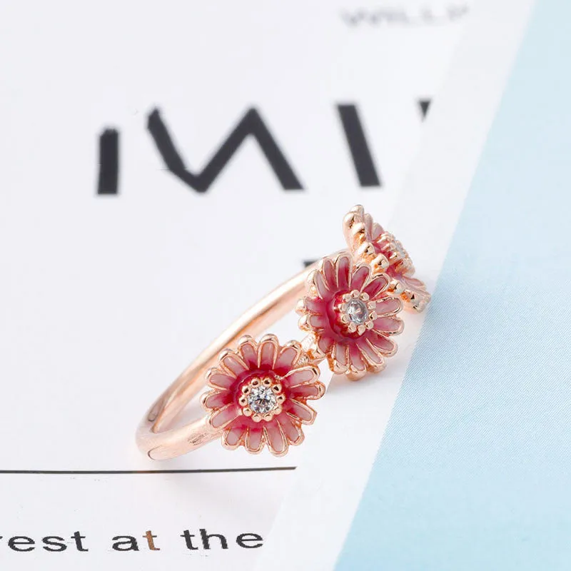 Three pink daisy rings with pink gemstone inlay in 925 sterling silver