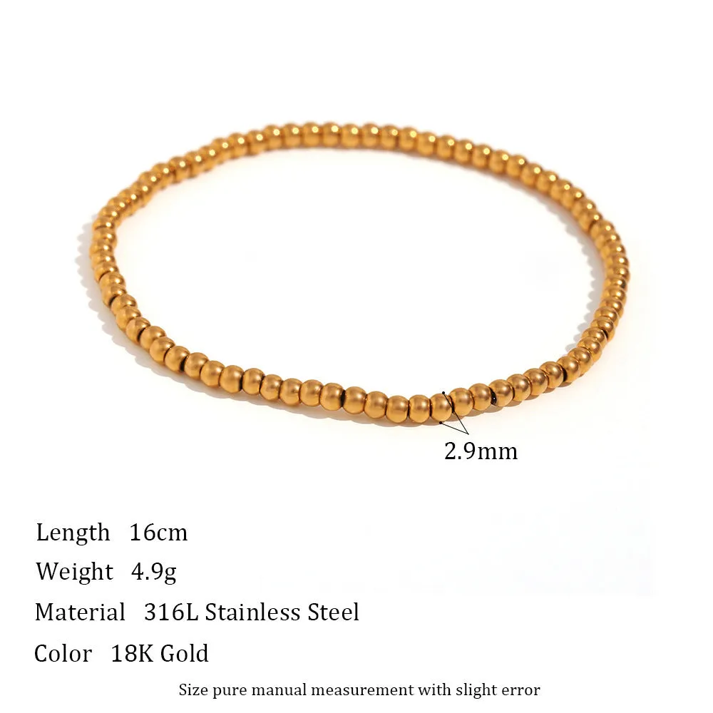 Stainless steel plated elastic bead bracelet with round geometric beads in gold finish