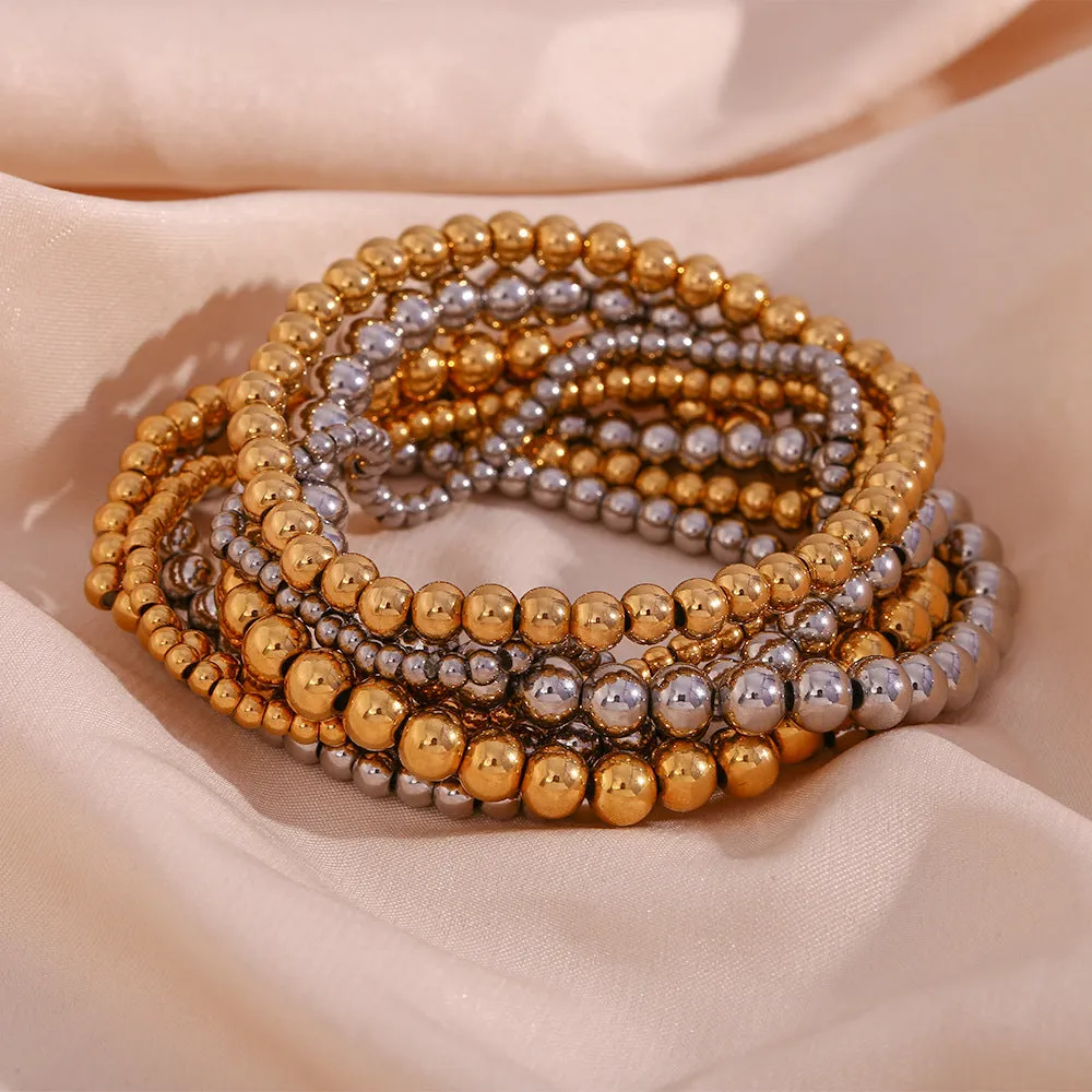 Stainless steel plated elastic bead bracelet with round geometric beads in gold finish
