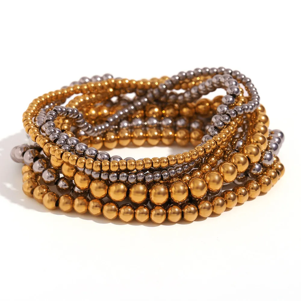 Stainless steel plated elastic bead bracelet with round geometric beads in gold finish