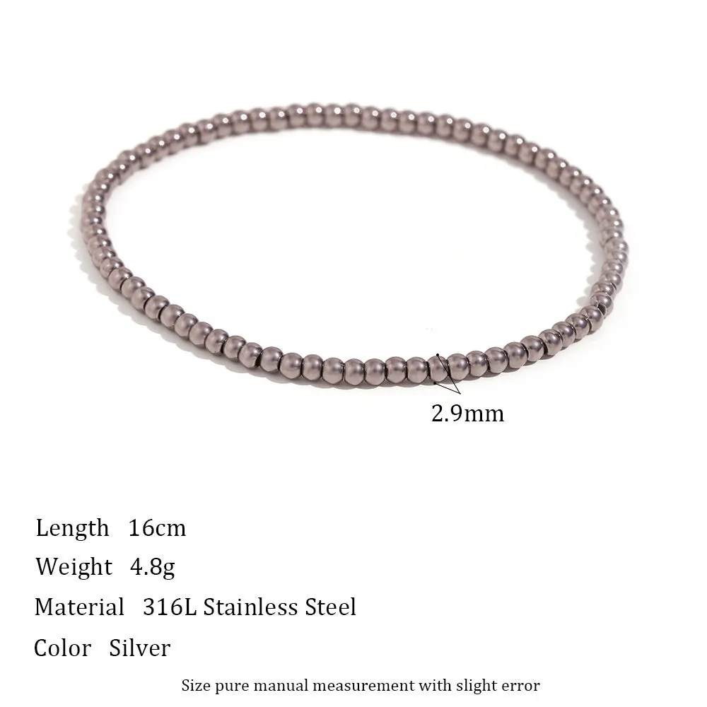 Stainless steel plated elastic bead bracelet with round geometric beads in gold finish