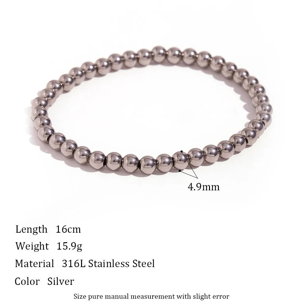 Stainless steel plated elastic bead bracelet with round geometric beads in gold finish