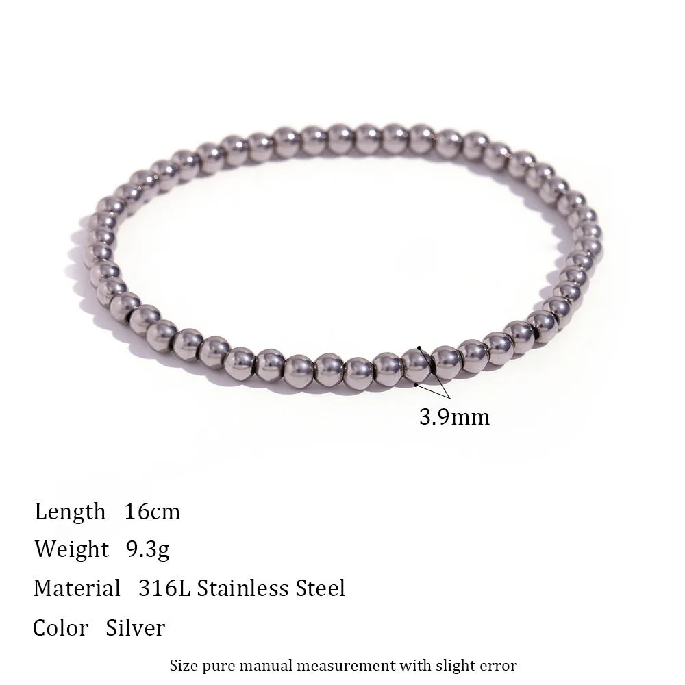 Stainless steel plated elastic bead bracelet with round geometric beads in gold finish
