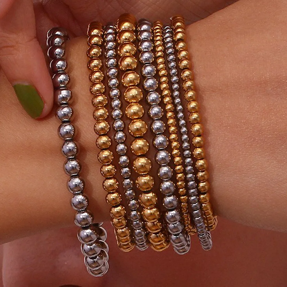 Stainless steel plated elastic bead bracelet with round geometric beads in gold finish