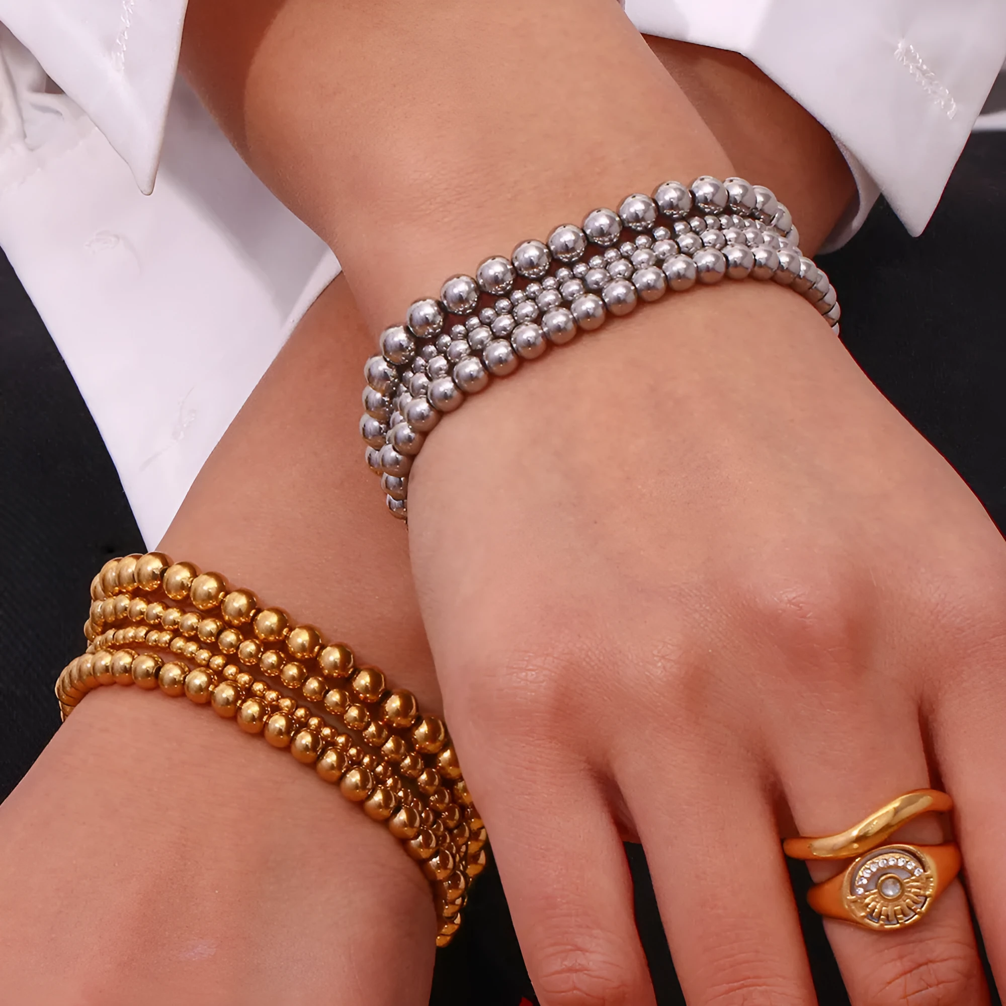 Stainless steel plated elastic bead bracelet with round geometric beads in gold finish