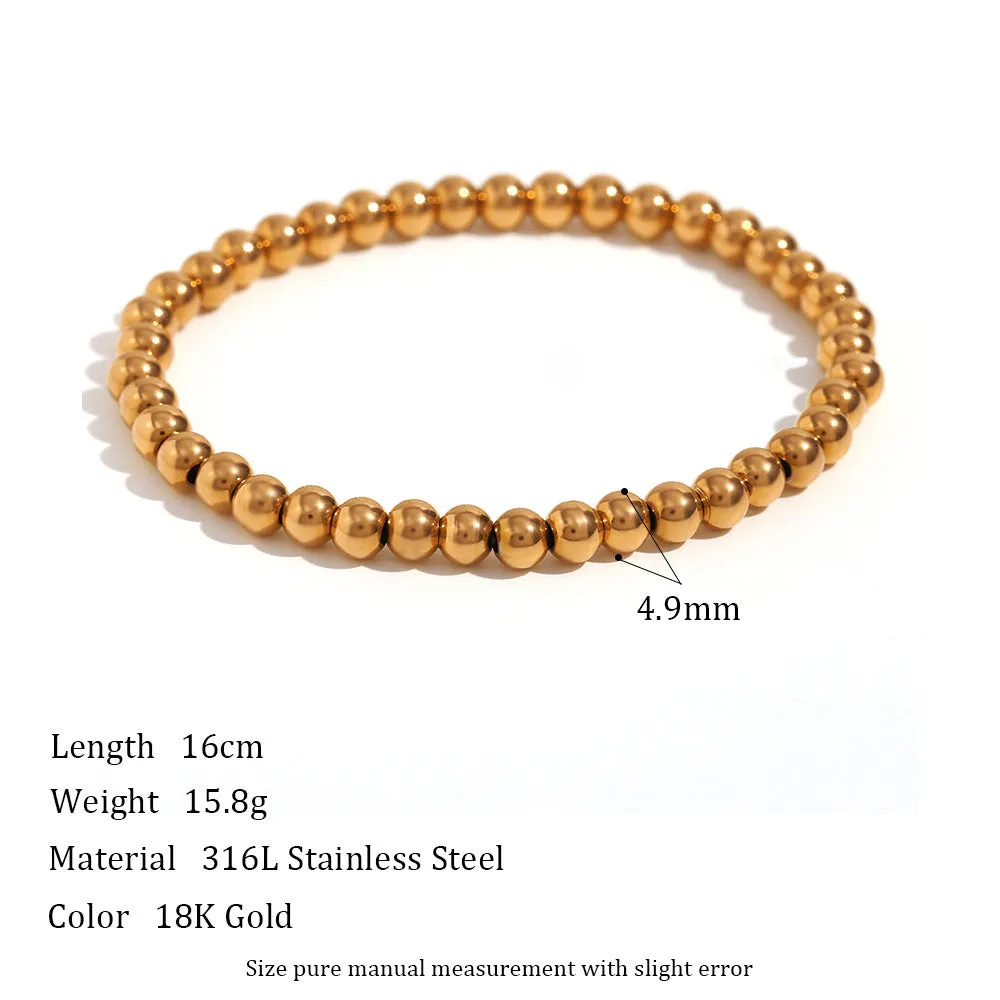 Stainless steel plated elastic bead bracelet with round geometric beads in gold finish