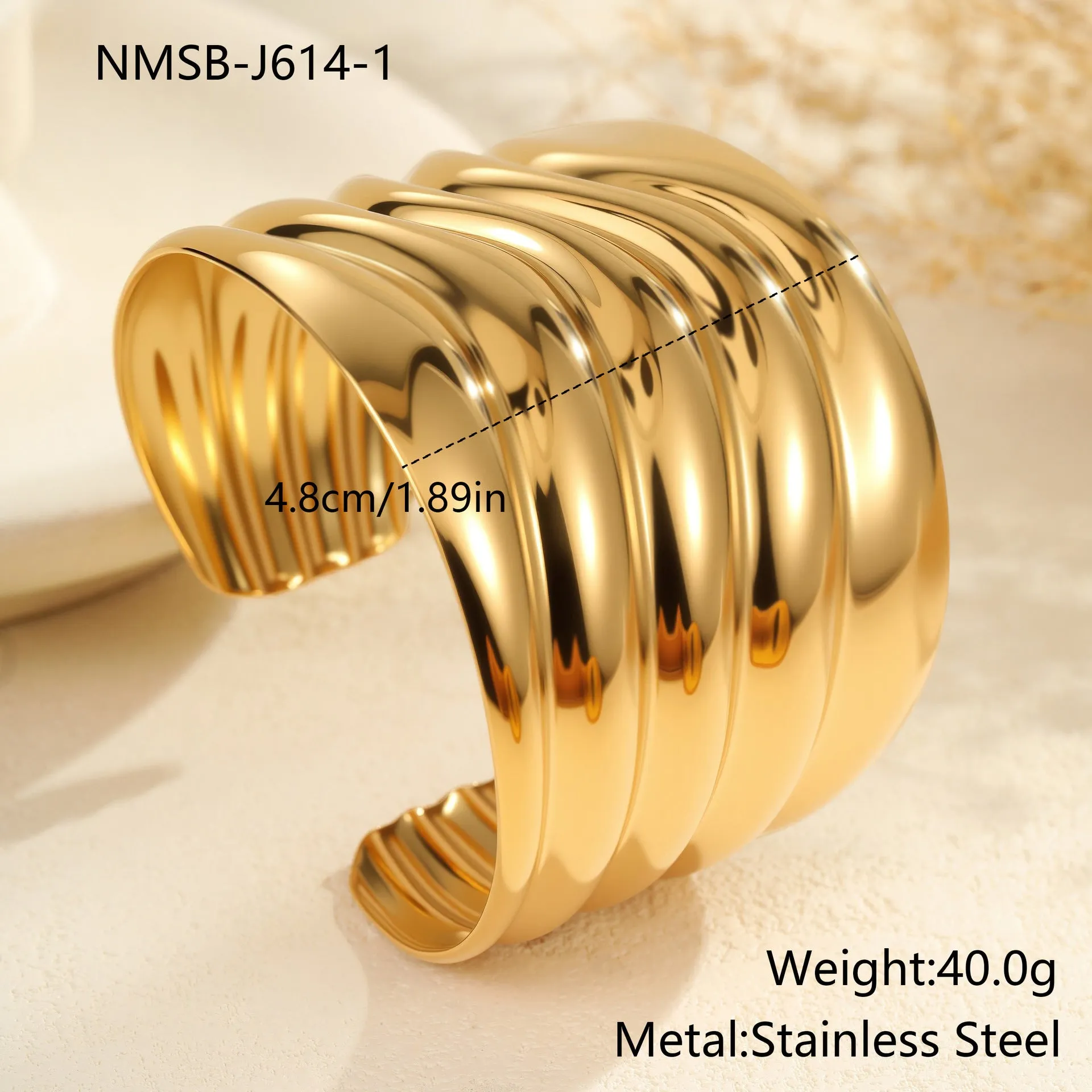 Women's wide geometric wave bracelet with gold plating and niche opening detail on wrist