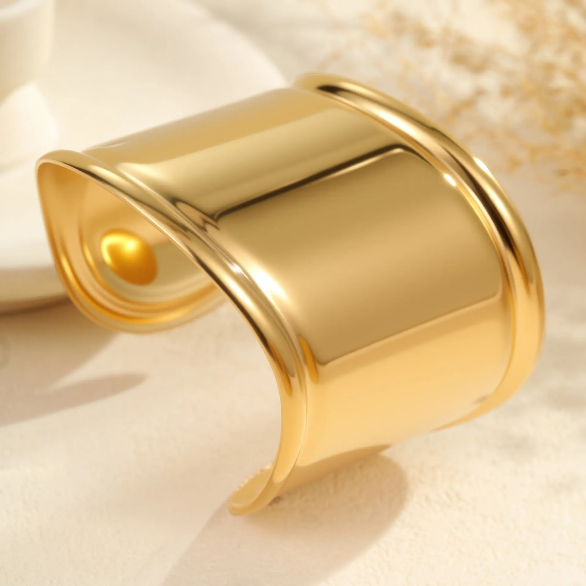 Women's wide geometric wave bracelet with gold plating and niche opening detail on wrist