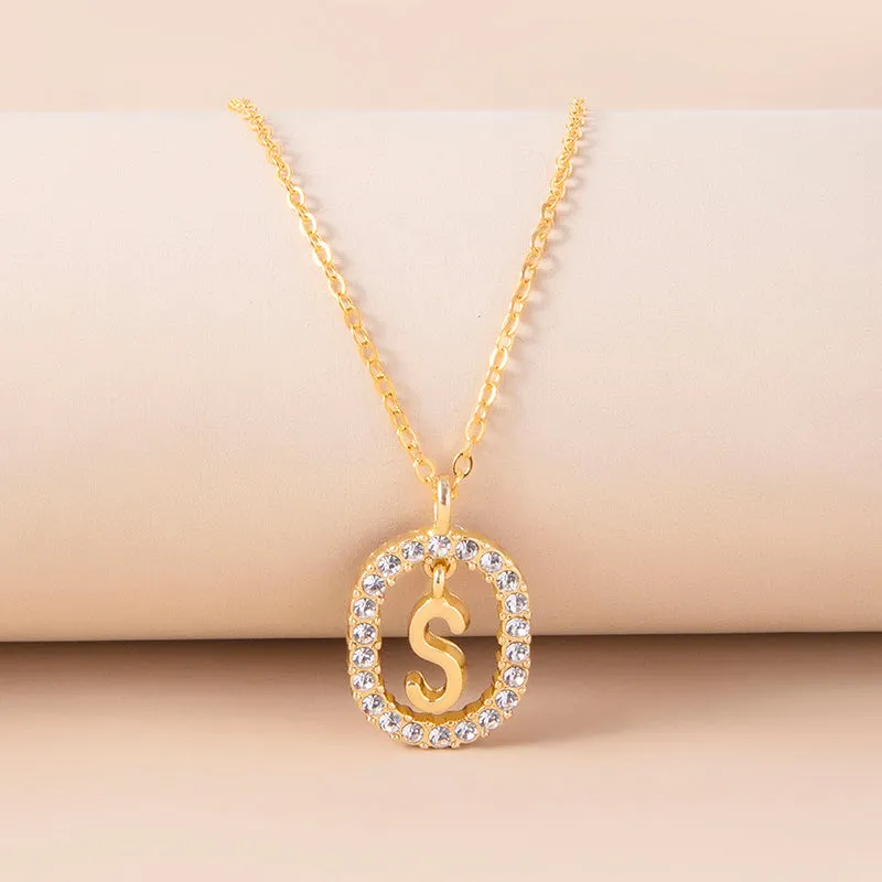Gold crystal letter necklace with rhinestone initial on oval pendant and O-chain