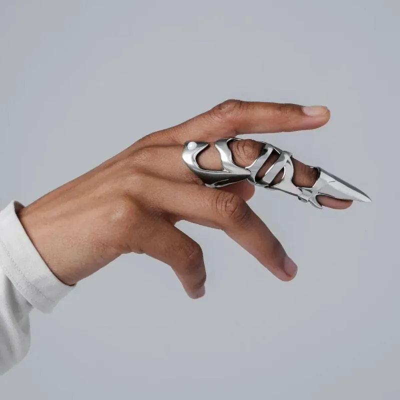 Silver-coloured alloy punk armour finger stall ring on a hand.