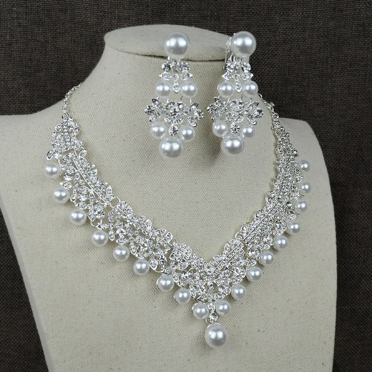 White pearl and crystal bridal set with necklace, earrings, and hair accessory on display