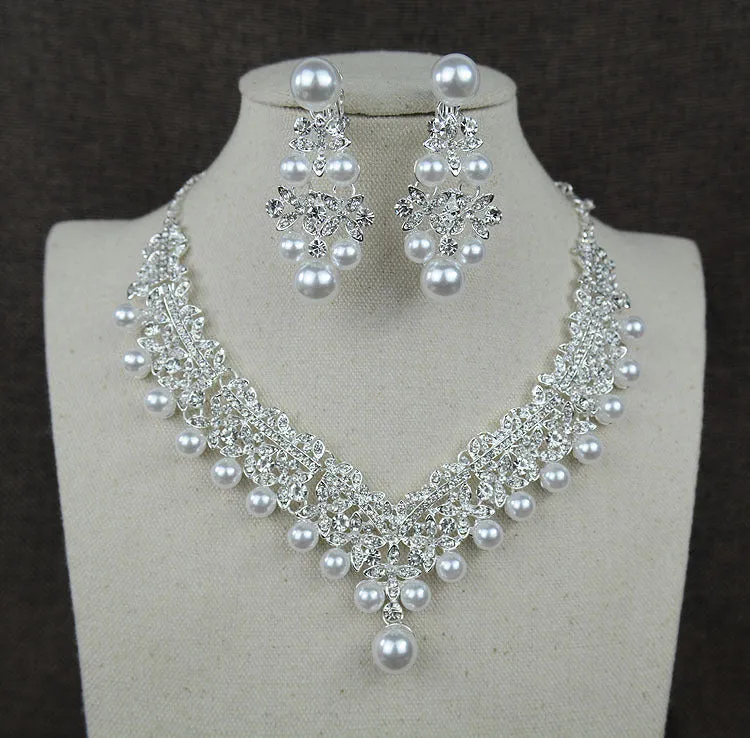 White pearl and crystal bridal set with necklace, earrings, and hair accessory on display