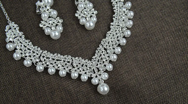 White pearl and crystal bridal set with necklace, earrings, and hair accessory on display