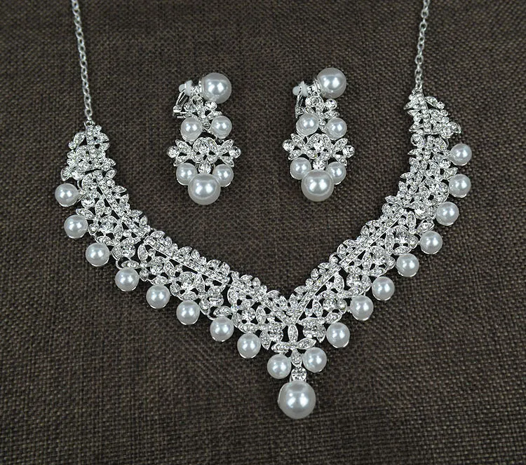White pearl and crystal bridal set with necklace, earrings, and hair accessory on display