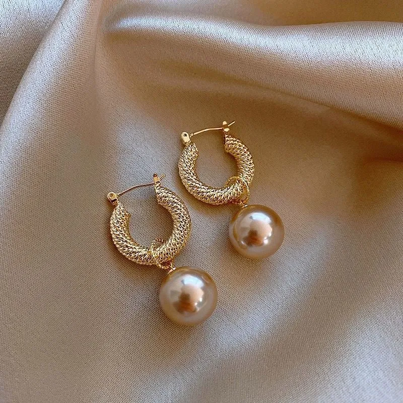 Geometric rose design women's electroplated copper earrings shown in one of the available colour variants.