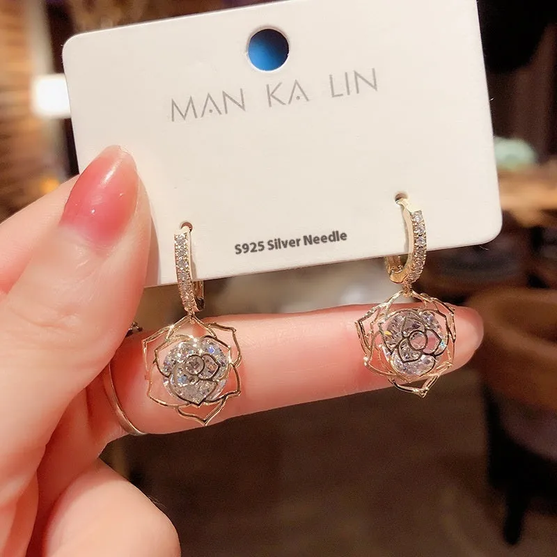 Geometric rose design women's electroplated copper earrings shown in one of the available colour variants.
