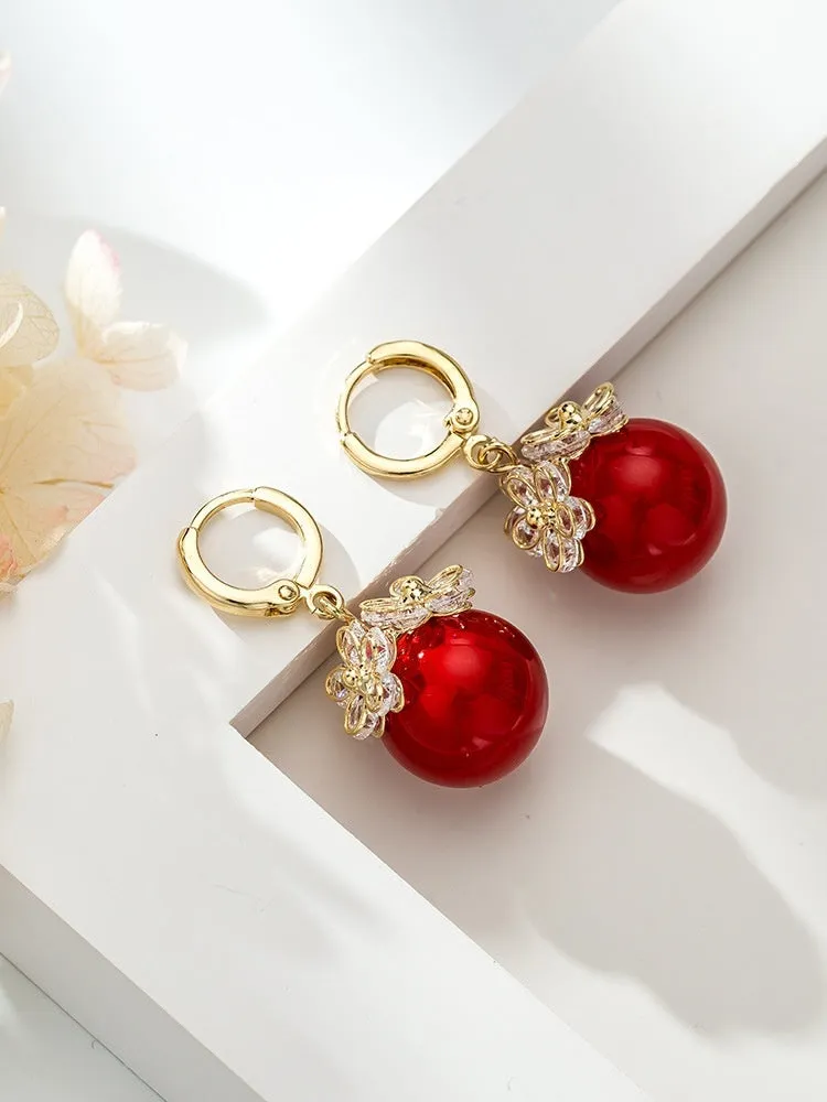 Geometric rose design women's electroplated copper earrings shown in one of the available colour variants.